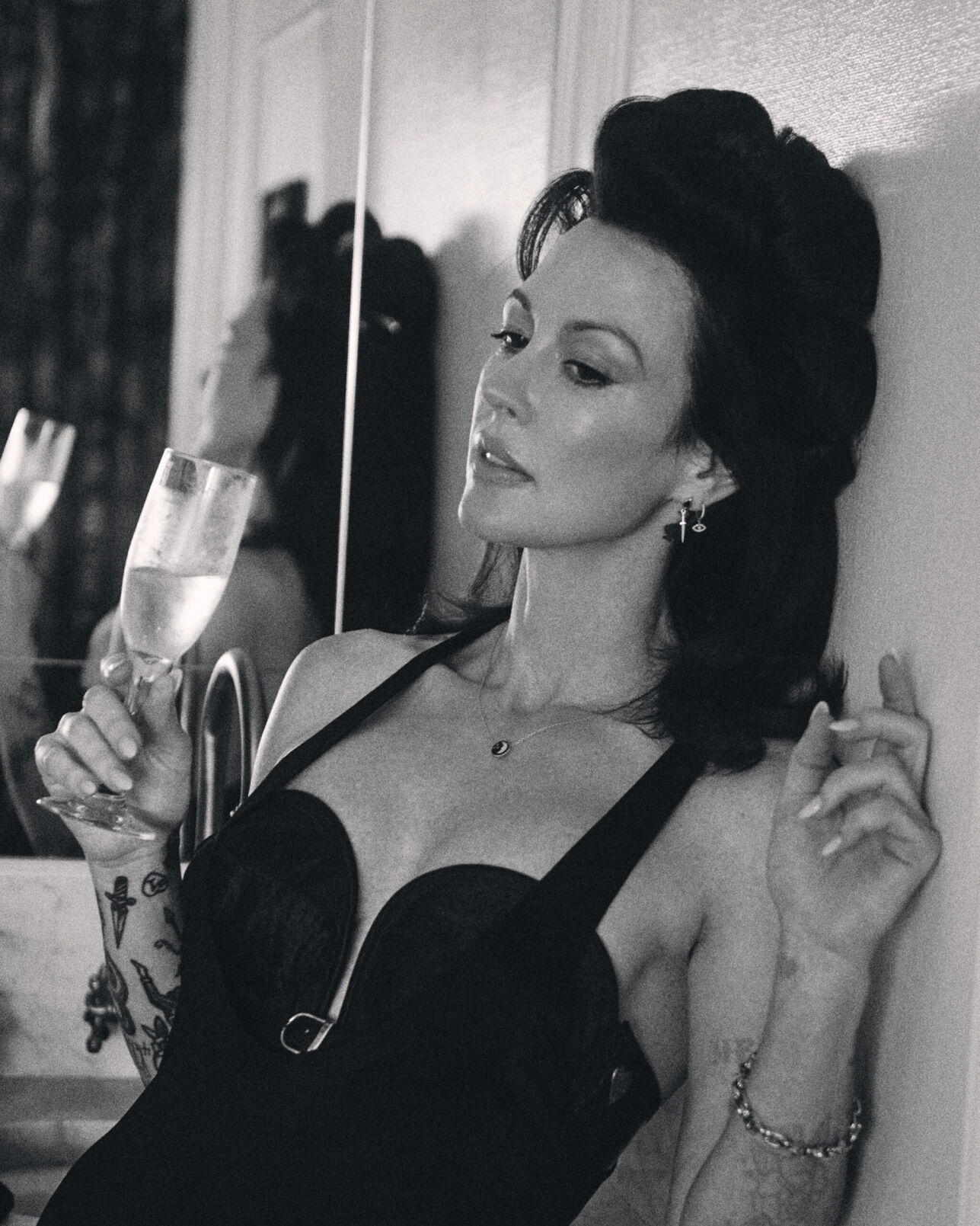 Amanda Shires press photo black-and-white artist sips a glass of champagne